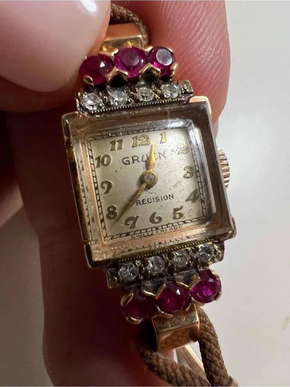 Gruen Precision wristwatch crafted in 14k rose gold with rubies and diamonds